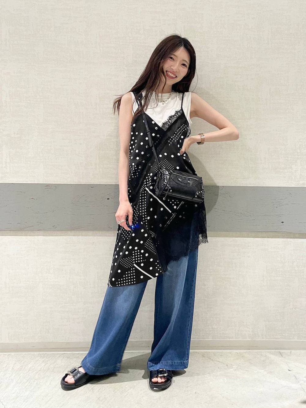 グリーン系のTシャツ/カットソー、ブラック系のサンダル、ブルー系のデニムパンツを着用したレディースの夏コーディネートの5枚目の写真