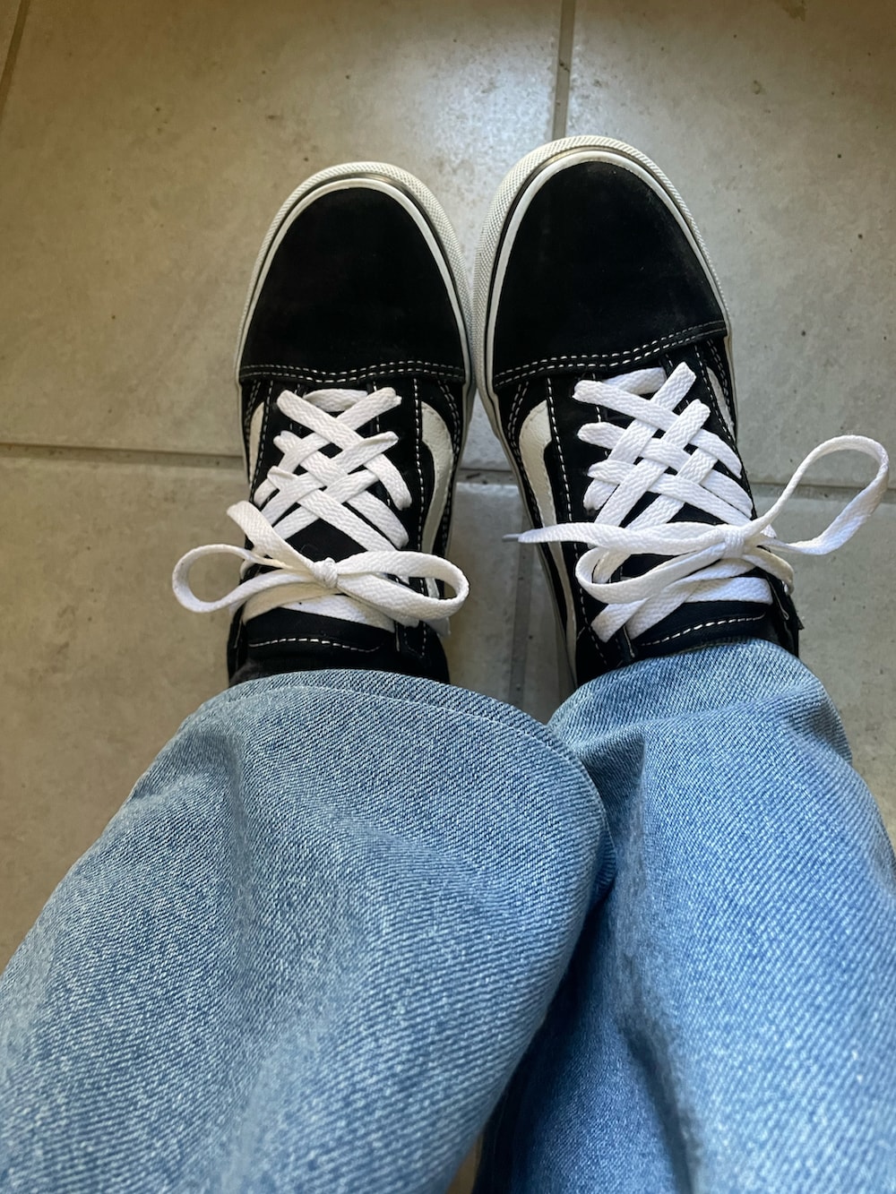 ブルー系のデニムパンツ、ブラック系のスニーカー、シルバー系のブレスレットを着用したレディースの冬コーディネートの2枚目の写真