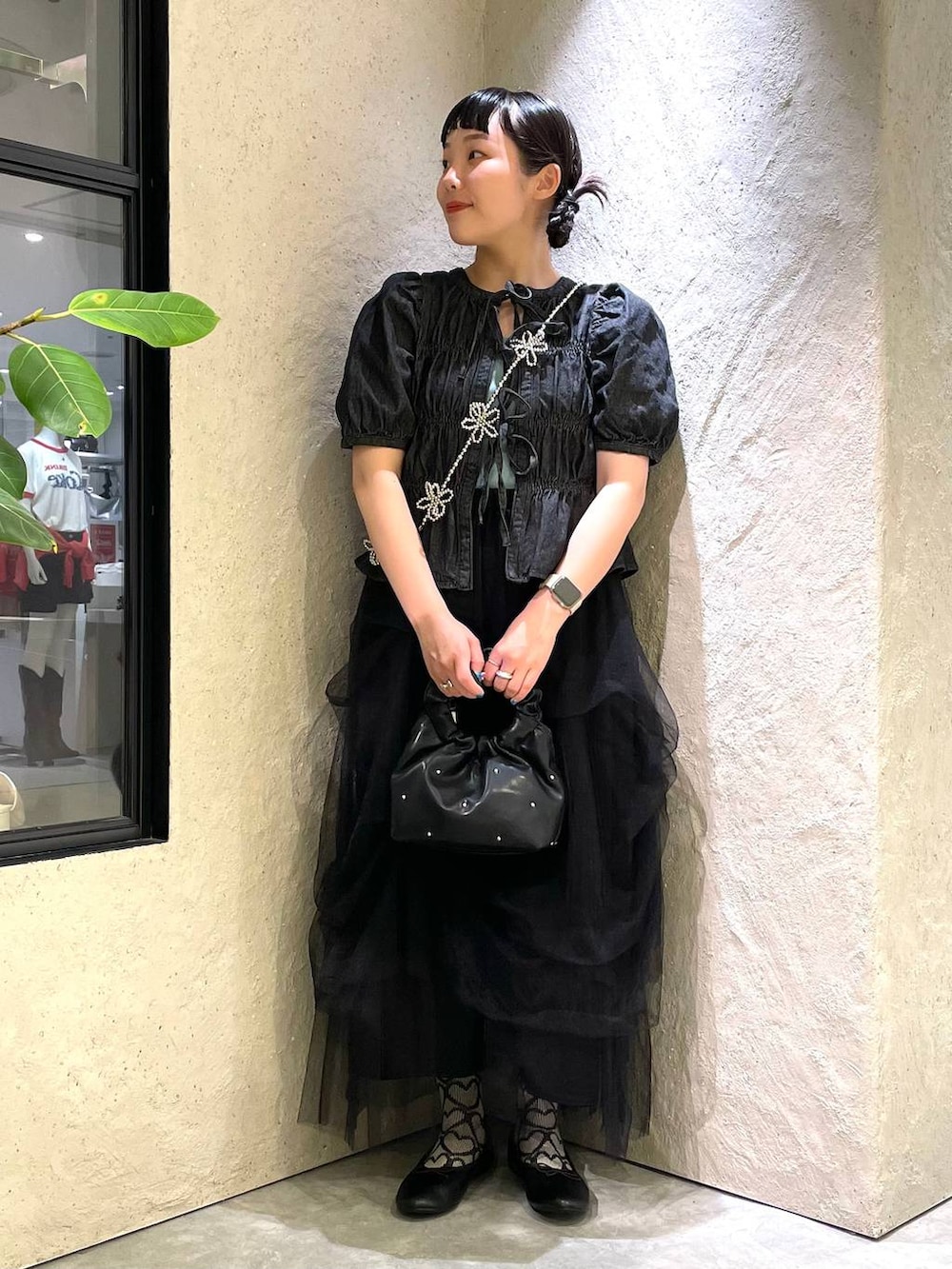 ブラック系のハンドバッグ、ブルー系のタンクトップ、ブラック系のバレエシューズを着用したレディースの春コーディネートの2枚目の写真