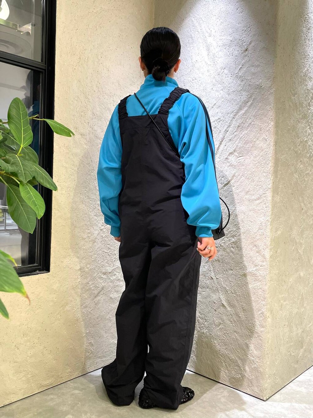 ブラック系のショルダーバッグ、ブルー系のサロペット/オーバーオール、ブルー系のTシャツ/カットソーを着用したレディースの春コーディネートの6枚目の写真