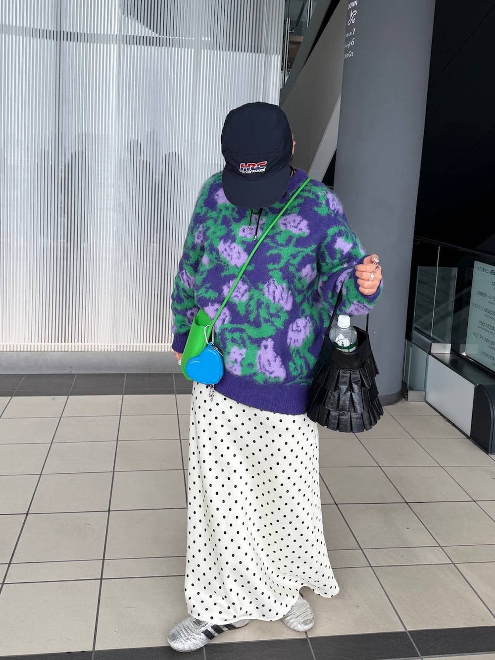 ホワイト系のスカート、ブラック系のハンドバッグ、ブラック系のネックレスを着用したレディースの冬コーディネートの5枚目の写真