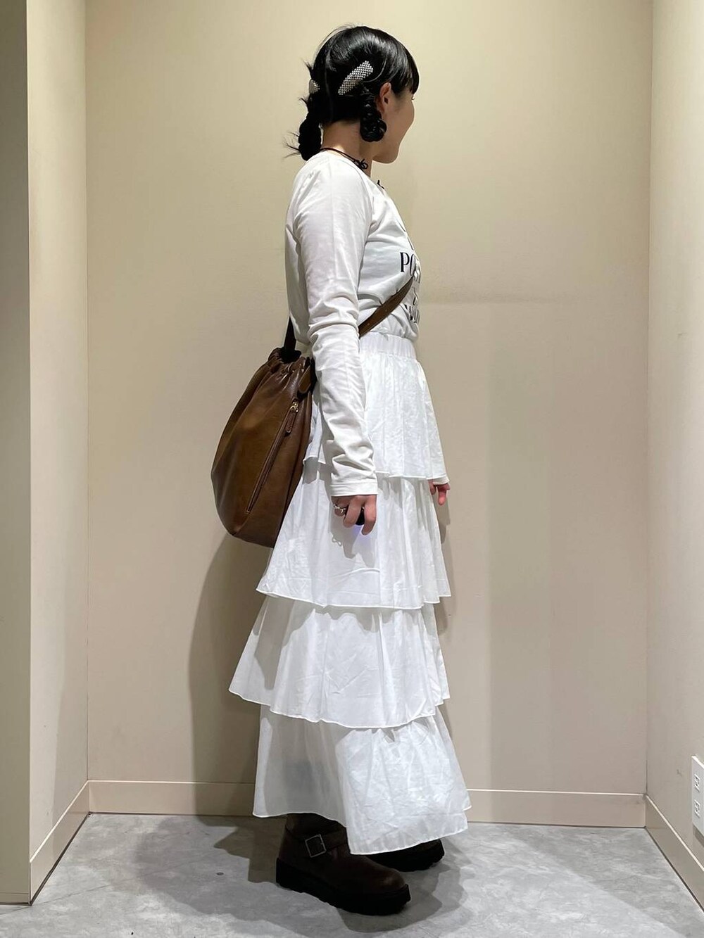 グリーン系のその他アウター、ブラウン系のブーツ、ホワイト系のスカートを着用したレディースの秋コーディネートの8枚目の写真