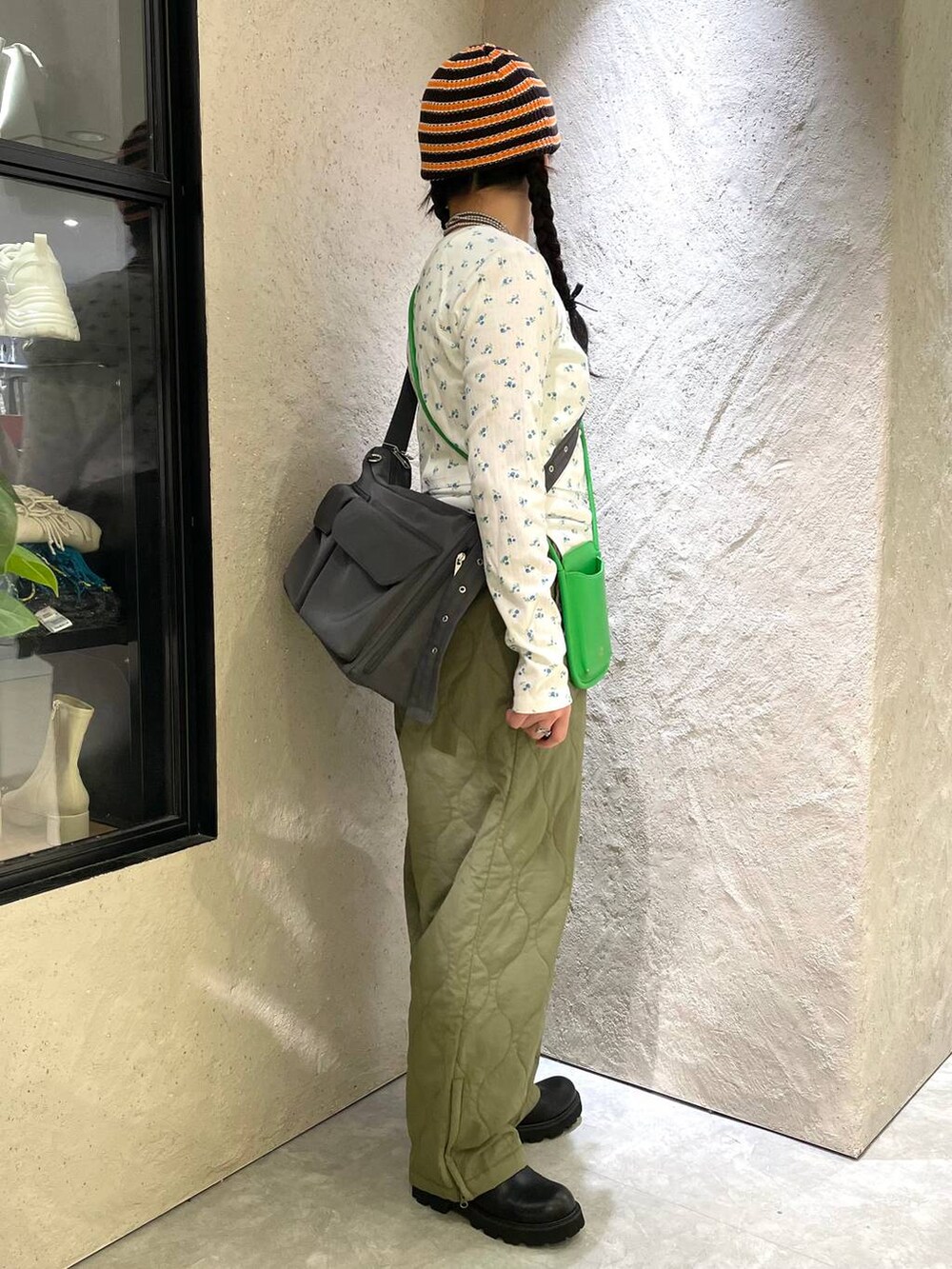 グリーン系のその他パンツ、ブラック系のキャミソール、ブラック系のブーツを着用したレディースの冬コーディネートの6枚目の写真