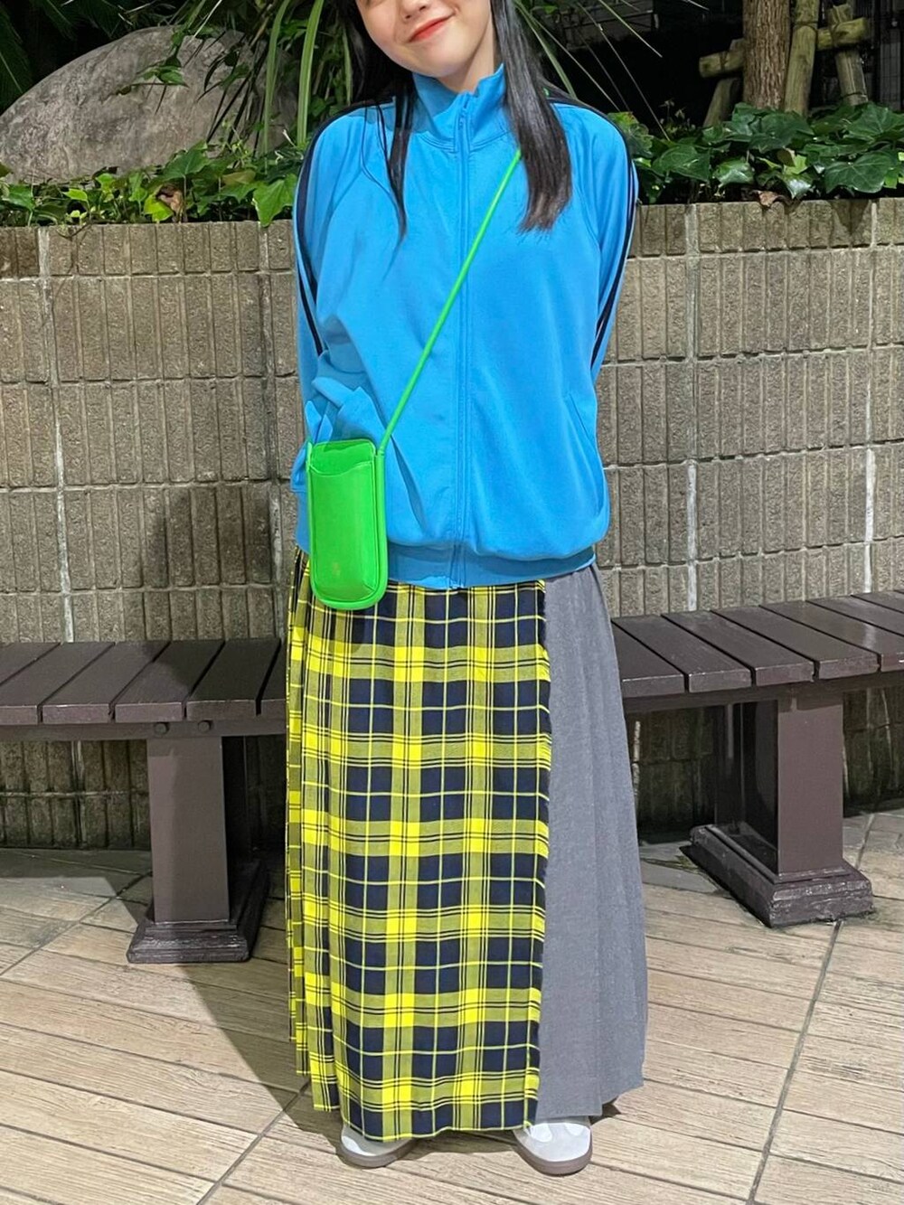 ホワイト系のスニーカー、イエロー系のスカート、ブルー系のTシャツ/カットソーを着用したレディースの秋コーディネートの2枚目の写真