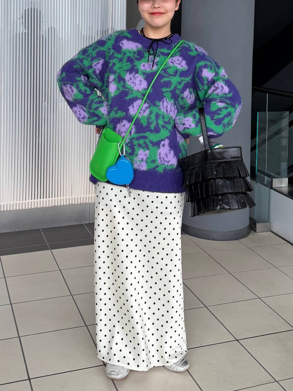 ホワイト系のスカート、ブラック系のハンドバッグ、ブラック系のネックレスを着用したレディースの冬コーディネートの3枚目の写真