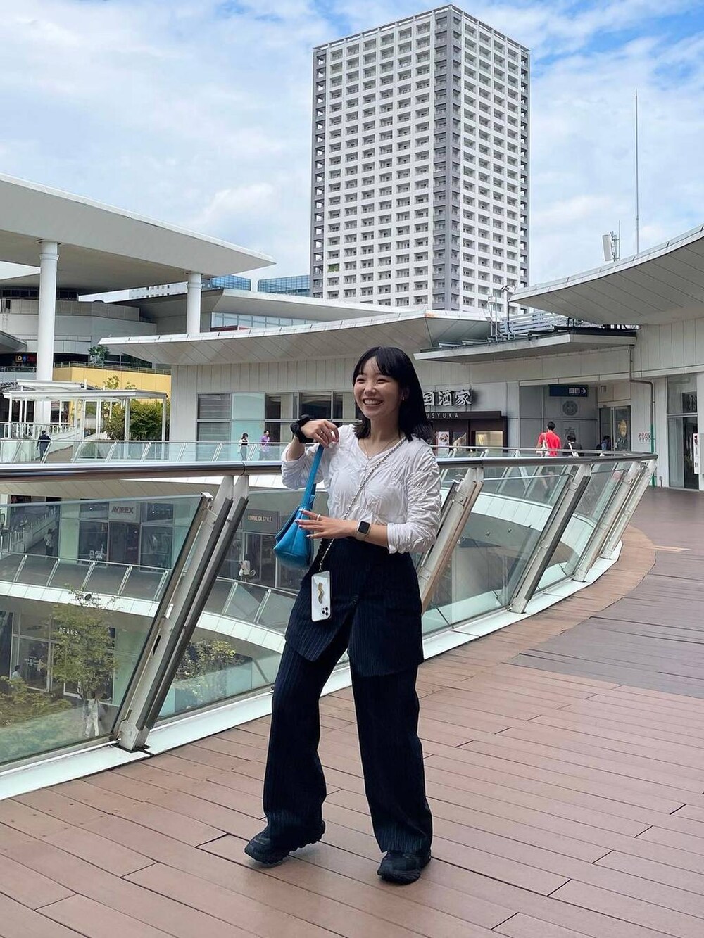 ブルー系のスラックス、その他のイヤリング、シルバー系のリングを着用したレディースの秋コーディネートの3枚目の写真