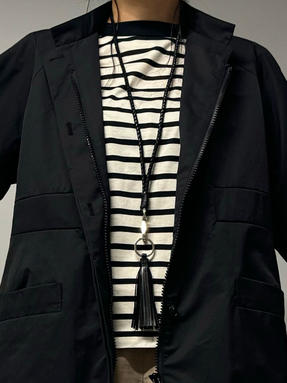 ブラック系のトートバッグ、ブラック系のブルゾン、ブラック系のTシャツ/カットソーを着用したレディースの秋コーディネートの5枚目の写真