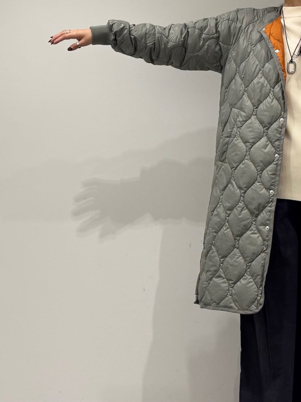 イエロー系のボストンバッグ、ブラック系のローファー、ホワイト系のベストを着用したレディースの秋コーディネートの7枚目の写真