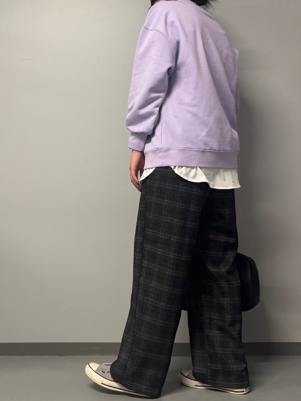 パープル系のスウェット、ブラック系のボストンバッグ、ブラウン系のその他パンツを着用したレディースの冬コーディネートの3枚目の写真