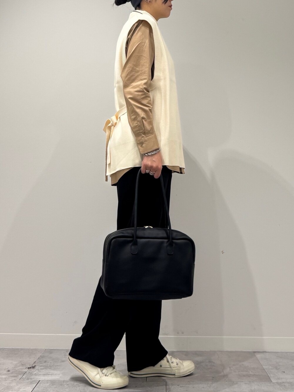 ブラック系のその他パンツ、ホワイト系のベスト、ベージュ系のシャツ/ブラウスを着用したレディースの秋コーディネートの2枚目の写真