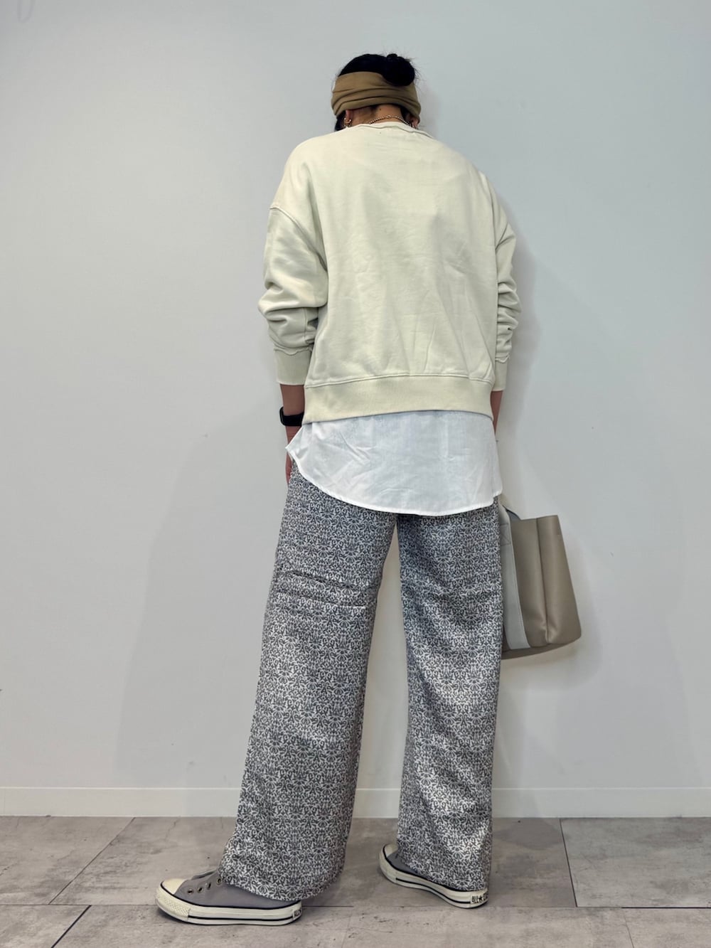 ホワイト系のスウェット、ベージュ系のトートバッグ、ブラック系のその他パンツを着用したレディースの秋コーディネートの5枚目の写真