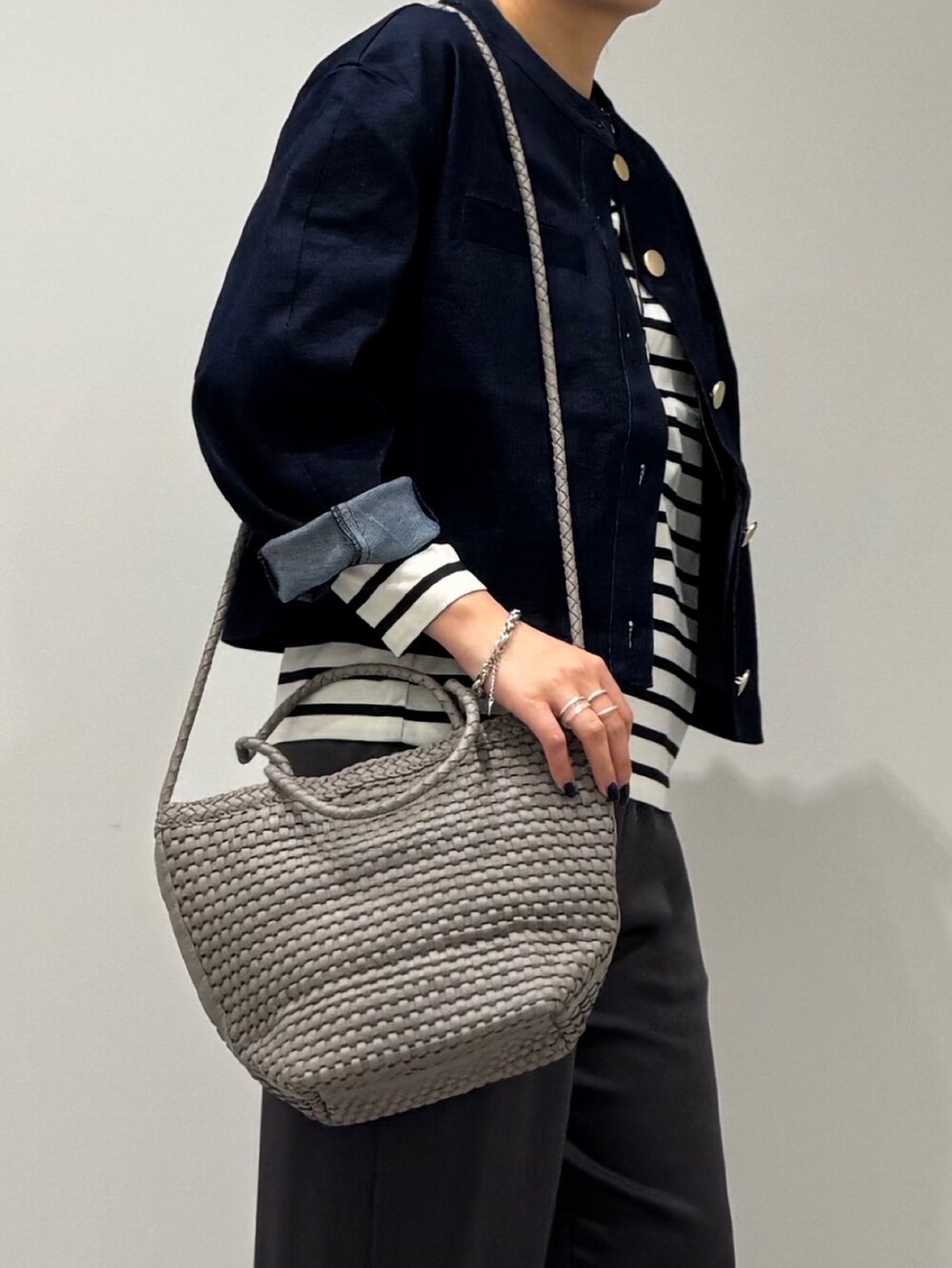 ベージュ系のトートバッグ、ブラック系のその他パンツ、ブラック系のTシャツ/カットソーを着用したレディースの秋コーディネートの6枚目の写真