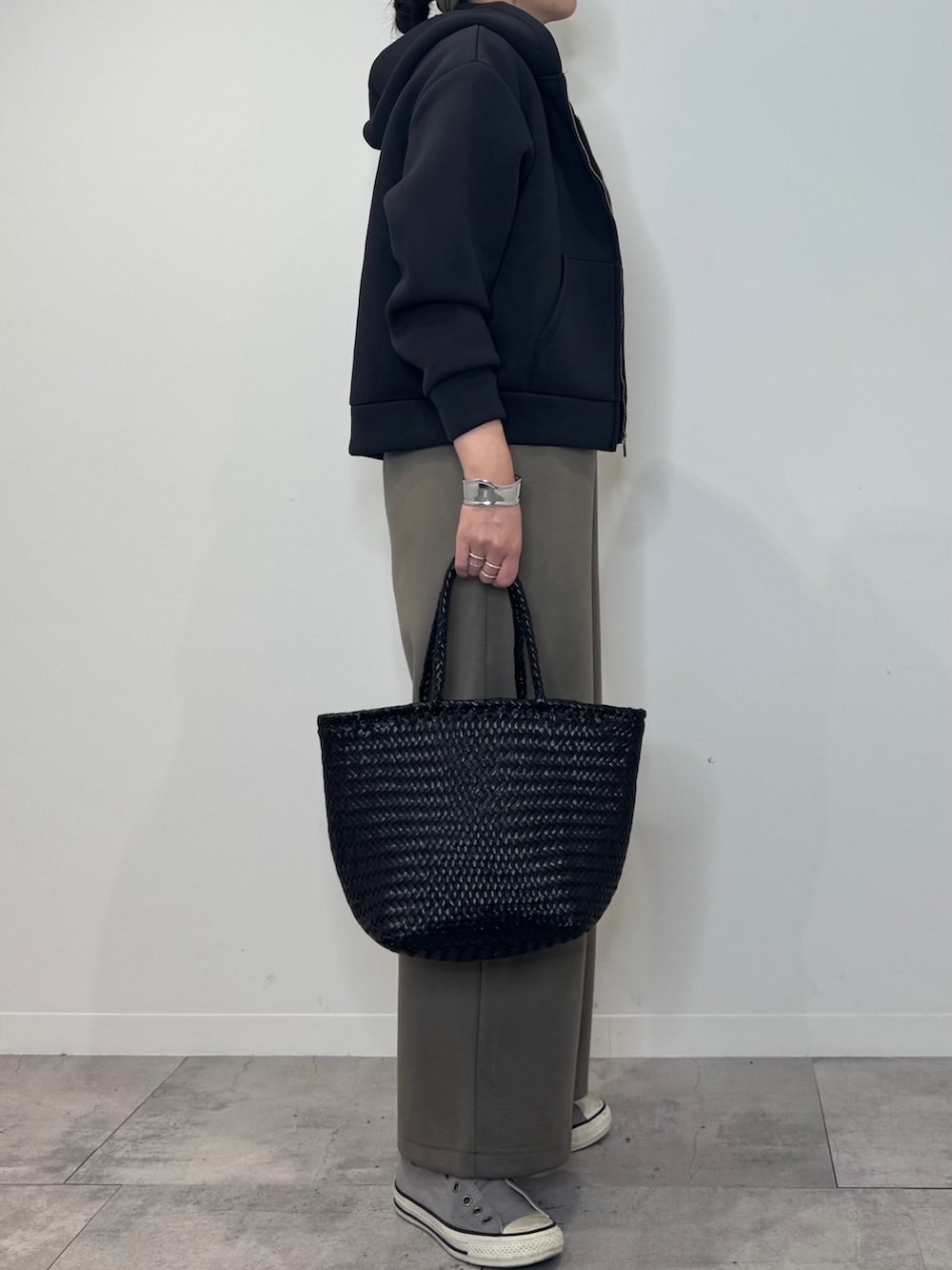 ブラウン系のサロペット/オーバーオール、ブラック系のトートバッグ、ブラック系のTシャツ/カットソーを着用したレディースの冬コーディネートの4枚目の写真