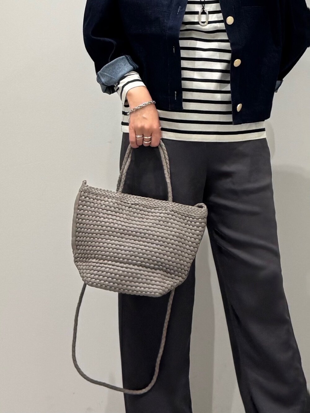 ベージュ系のトートバッグ、ブラック系のその他パンツ、ブラック系のTシャツ/カットソーを着用したレディースの秋コーディネートの7枚目の写真