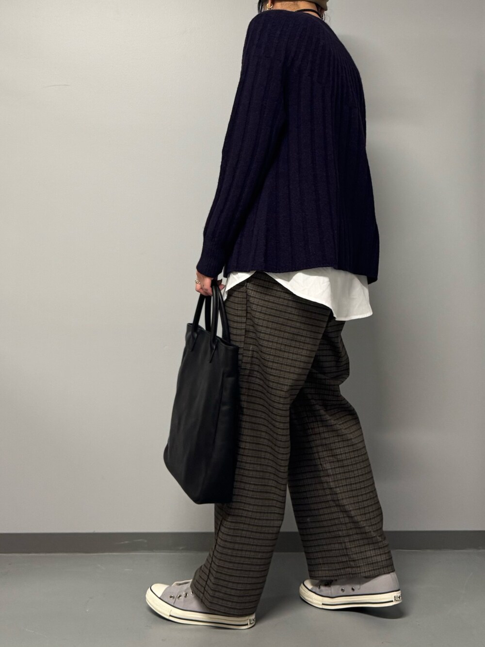 ブルー系のニット/セーター、ブラック系のトートバッグ、ブラウン系のその他パンツを着用したレディースの冬コーディネートの5枚目の写真