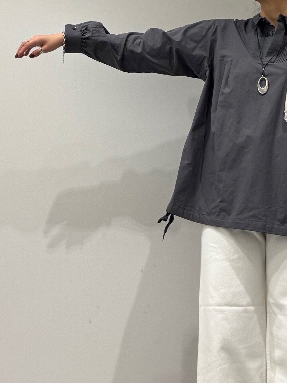 ブラウン系のトートバッグ、ホワイト系のデニムパンツ、ブラック系のローファーを着用したレディースの秋コーディネートの6枚目の写真