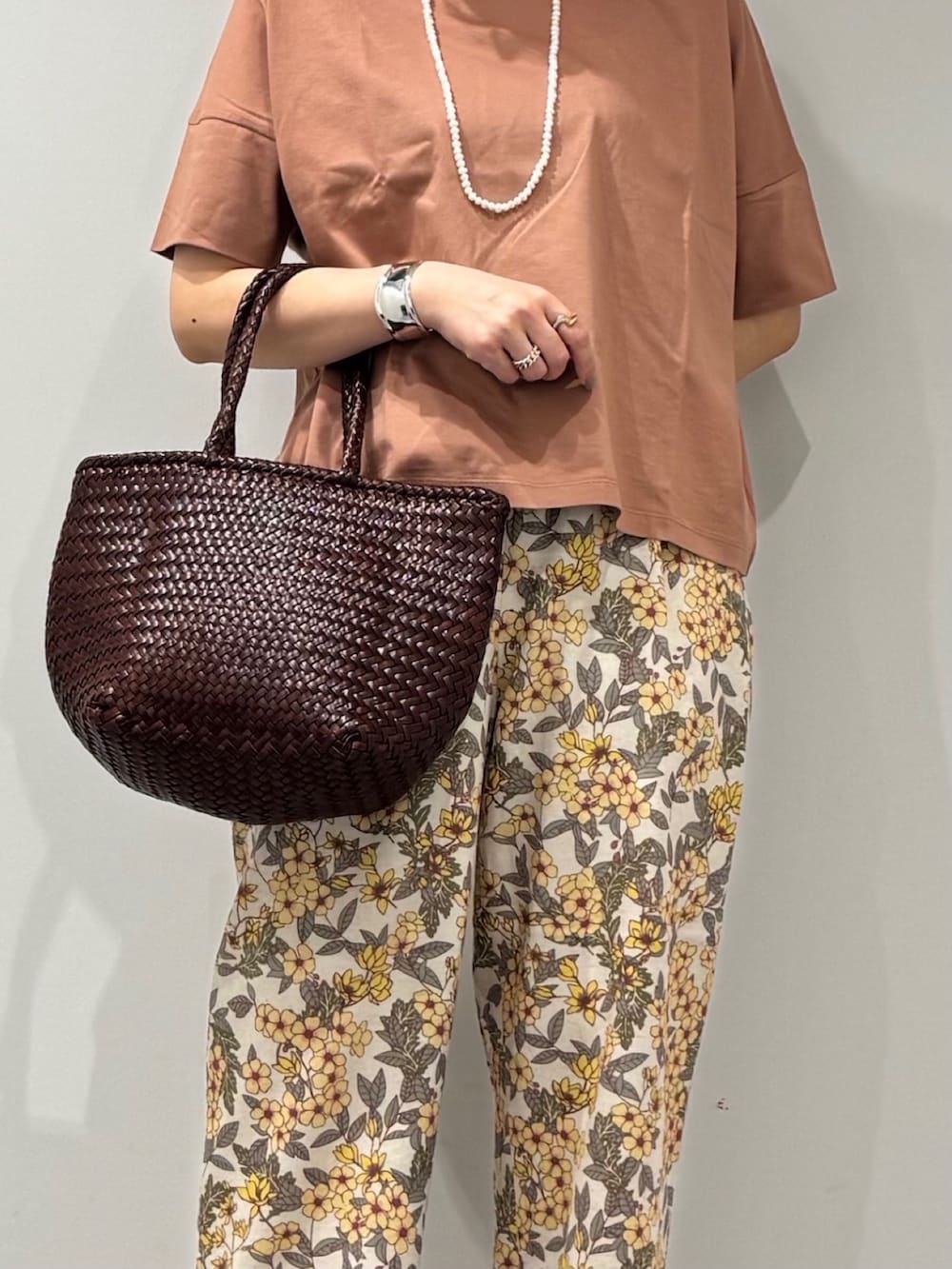 ブラウン系のトートバッグ、イエロー系のその他パンツ、ブラック系のサンダルを着用したレディースの春コーディネートの8枚目の写真