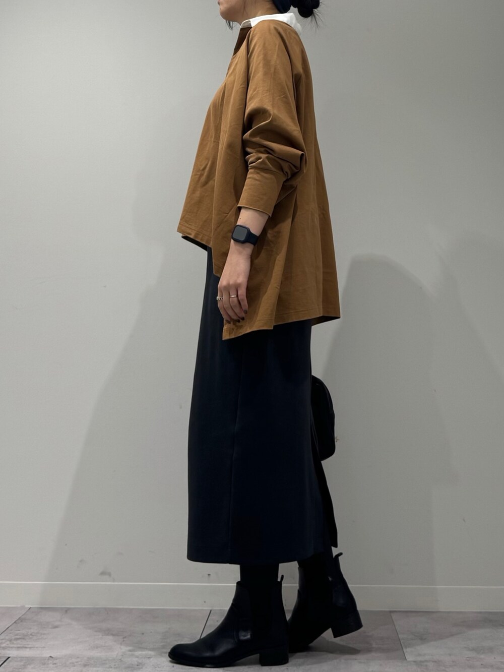 ブラック系のボストンバッグ、ベージュ系のTシャツ/カットソー、シルバー系のネックレスを着用したレディースの冬コーディネートの6枚目の写真