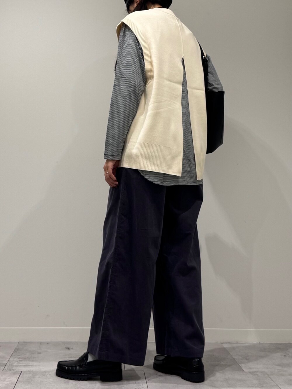 ブラック系のトートバッグ、グレー系のその他パンツ、ブラック系のローファーを着用したレディースの冬コーディネートの4枚目の写真