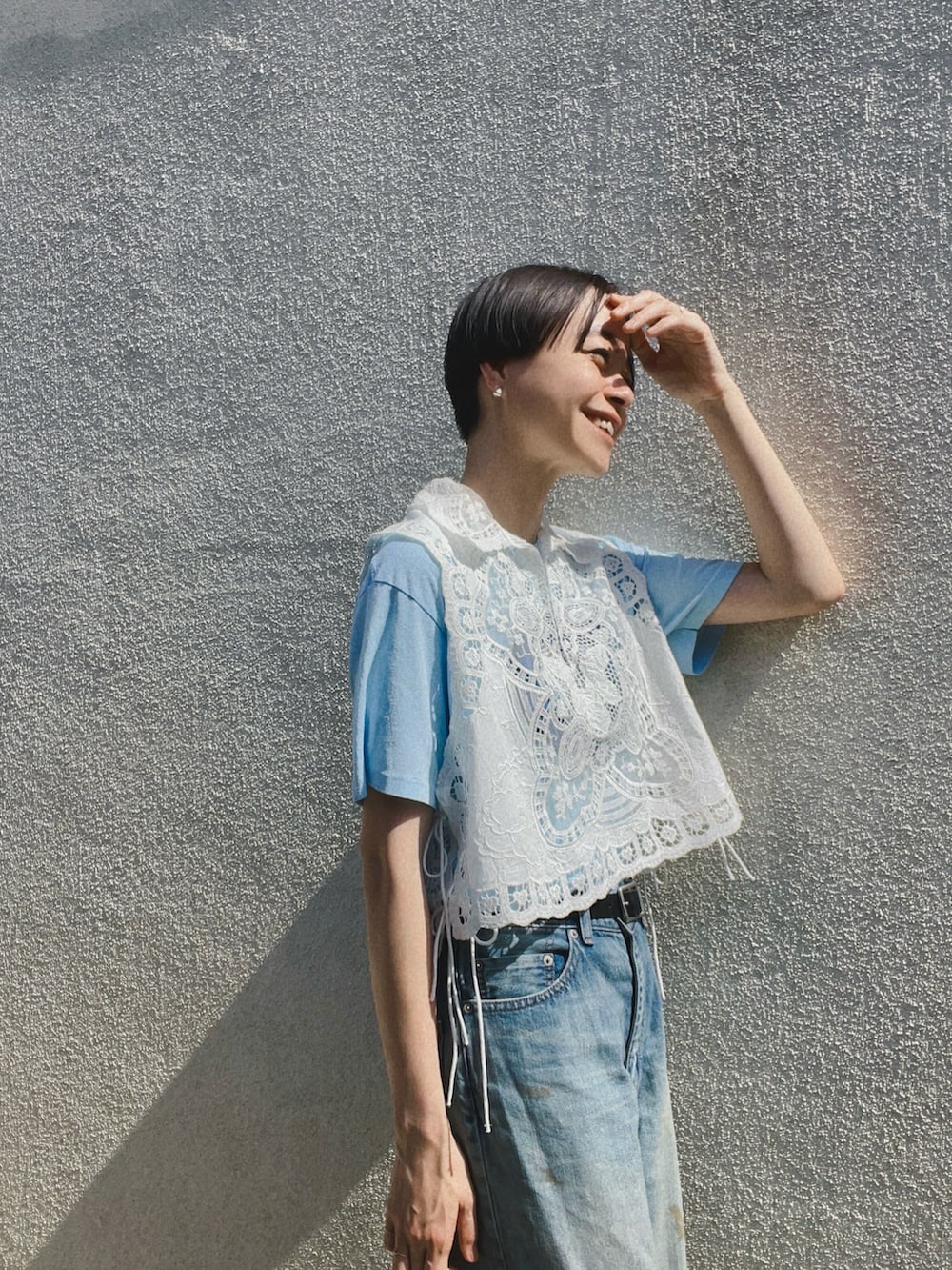 ホワイト系のシャツ/ブラウス、ブルー系のデニムパンツ、シルバー系のサンダルを着用したレディースの春コーディネートの2枚目の写真