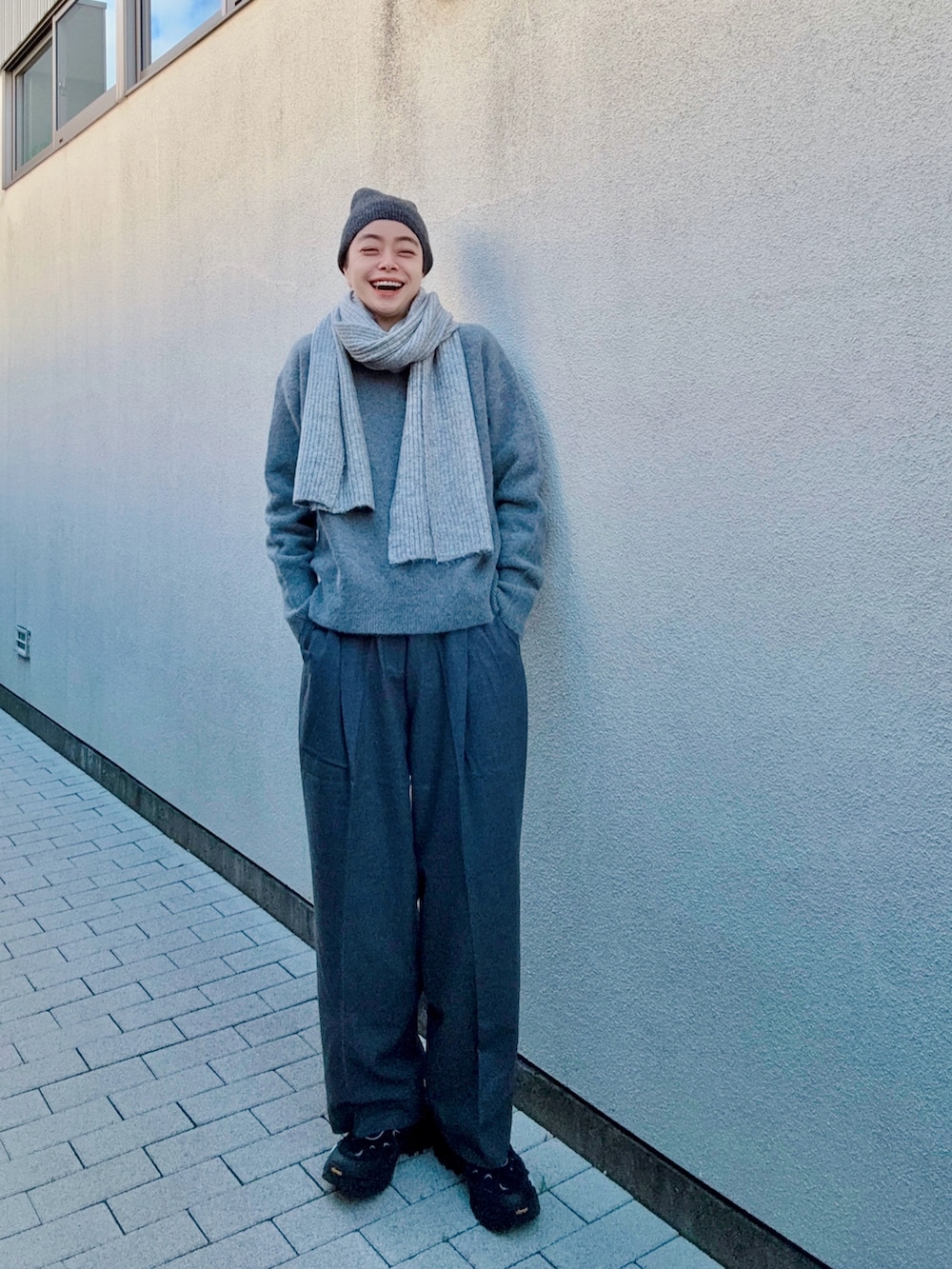 グレー系のニット/セーター、グレー系のその他パンツ、ブラック系のシューズを着用したレディースの冬コーディネートの2枚目の写真