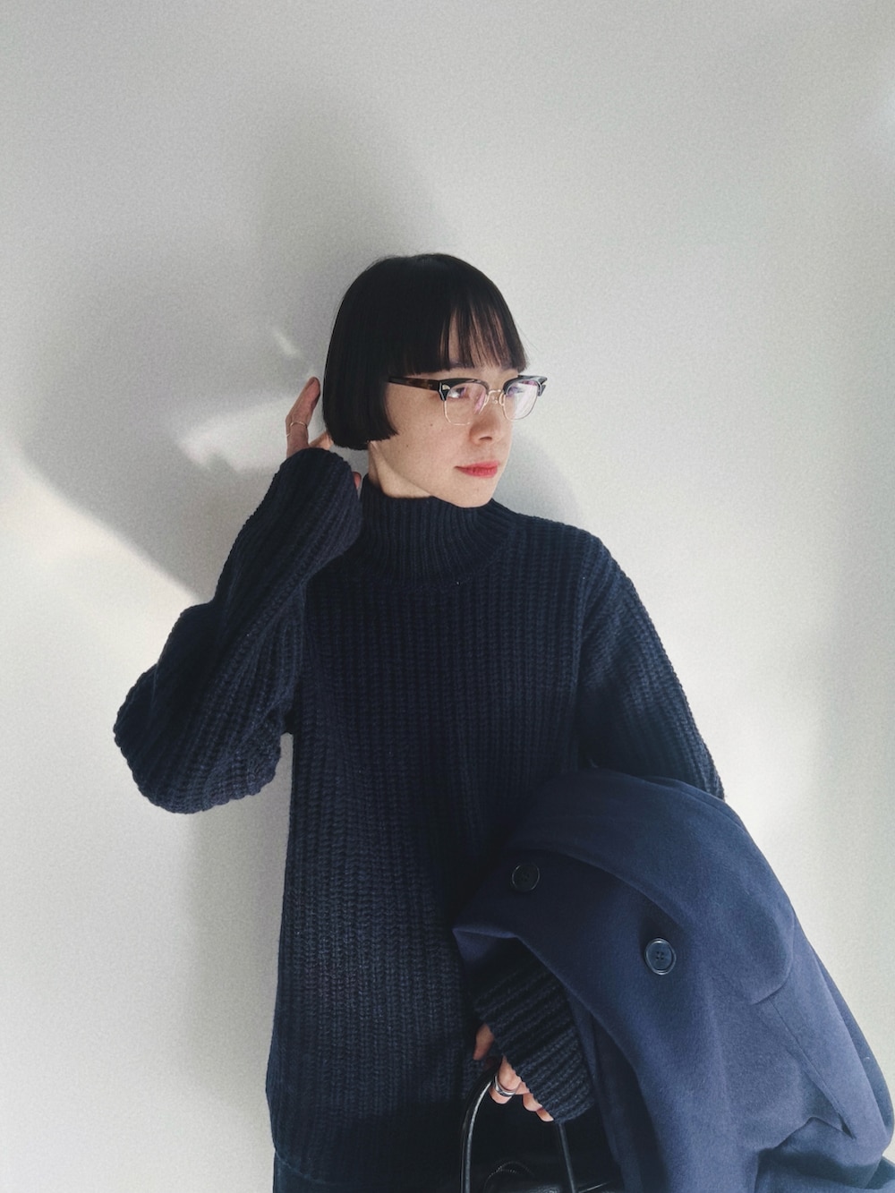 ブラック系のドレスシューズ、ブルー系のその他アウター、ブルー系のニット/セーターを着用したレディースの冬コーディネートの3枚目の写真