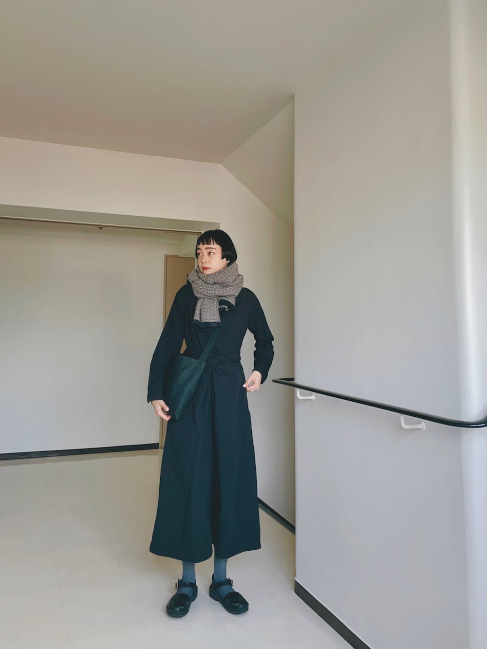 ブラック系のワンピース/ドレス、ブラック系のショルダーバッグ、ブラック系のシューズを着用したレディースの秋コーディネートの2枚目の写真