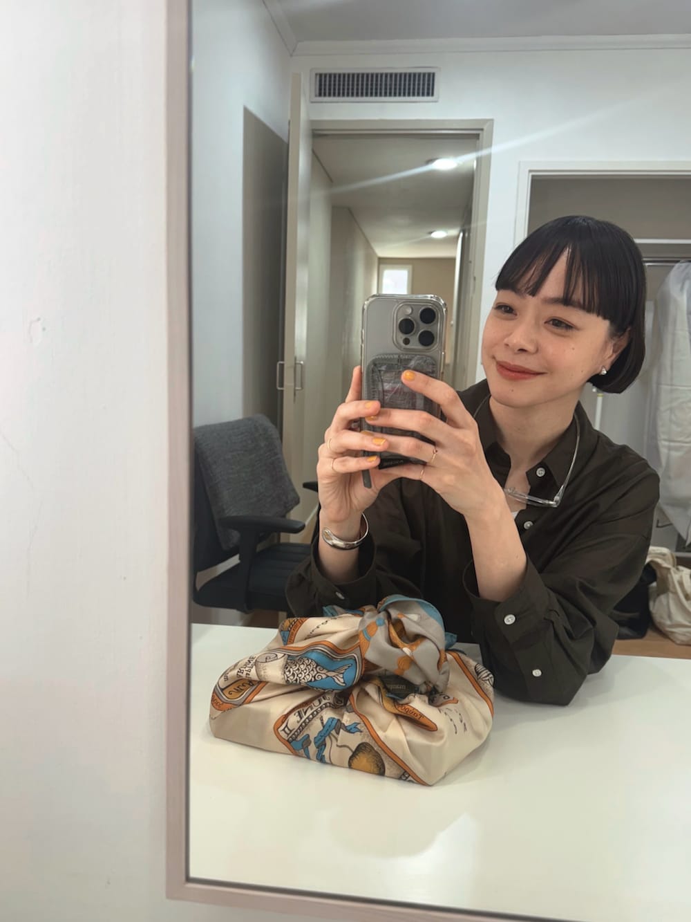 ブルー系のデニムパンツ、ブラウン系のシャツ/ブラウス、ベージュ系のローファーを着用したレディースの春コーディネートの4枚目の写真