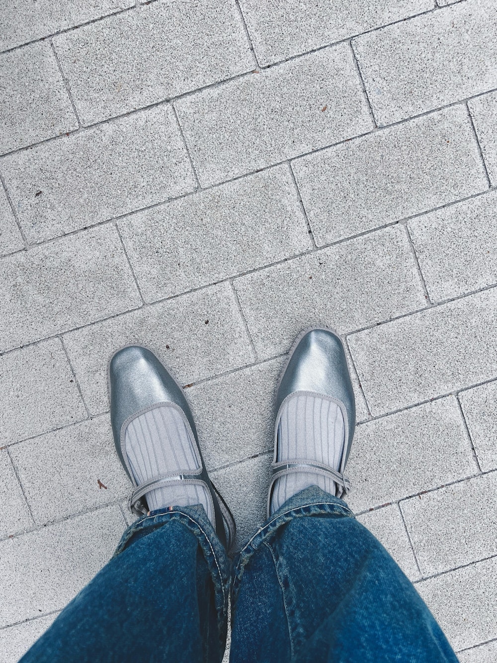 ブルー系のカーディガン/ボレロ、ブルー系のデニムパンツ、シルバー系のシューズを着用したレディースの春コーディネートの2枚目の写真