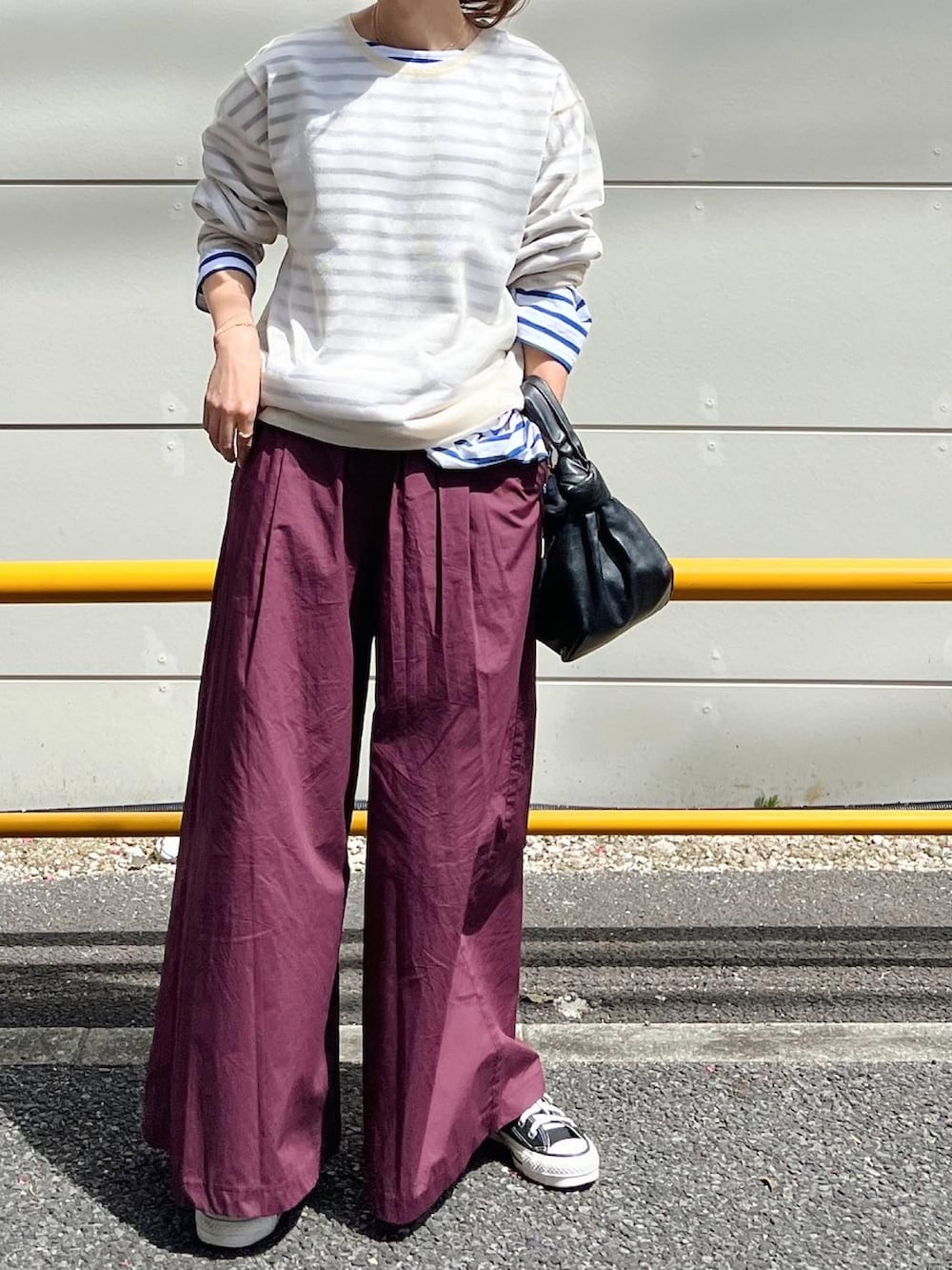 レッド系のその他パンツ、ブラック系のバッグ、グリーン系のスニーカーを着用したレディースの春コーディネートの2枚目の写真