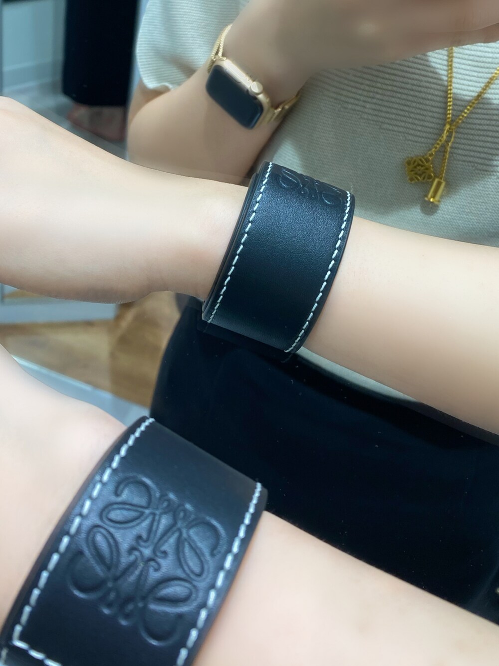 ブラック系のスカート、ベージュ系のニット/セーターを着用したレディースの夏コーディネートの3枚目の写真