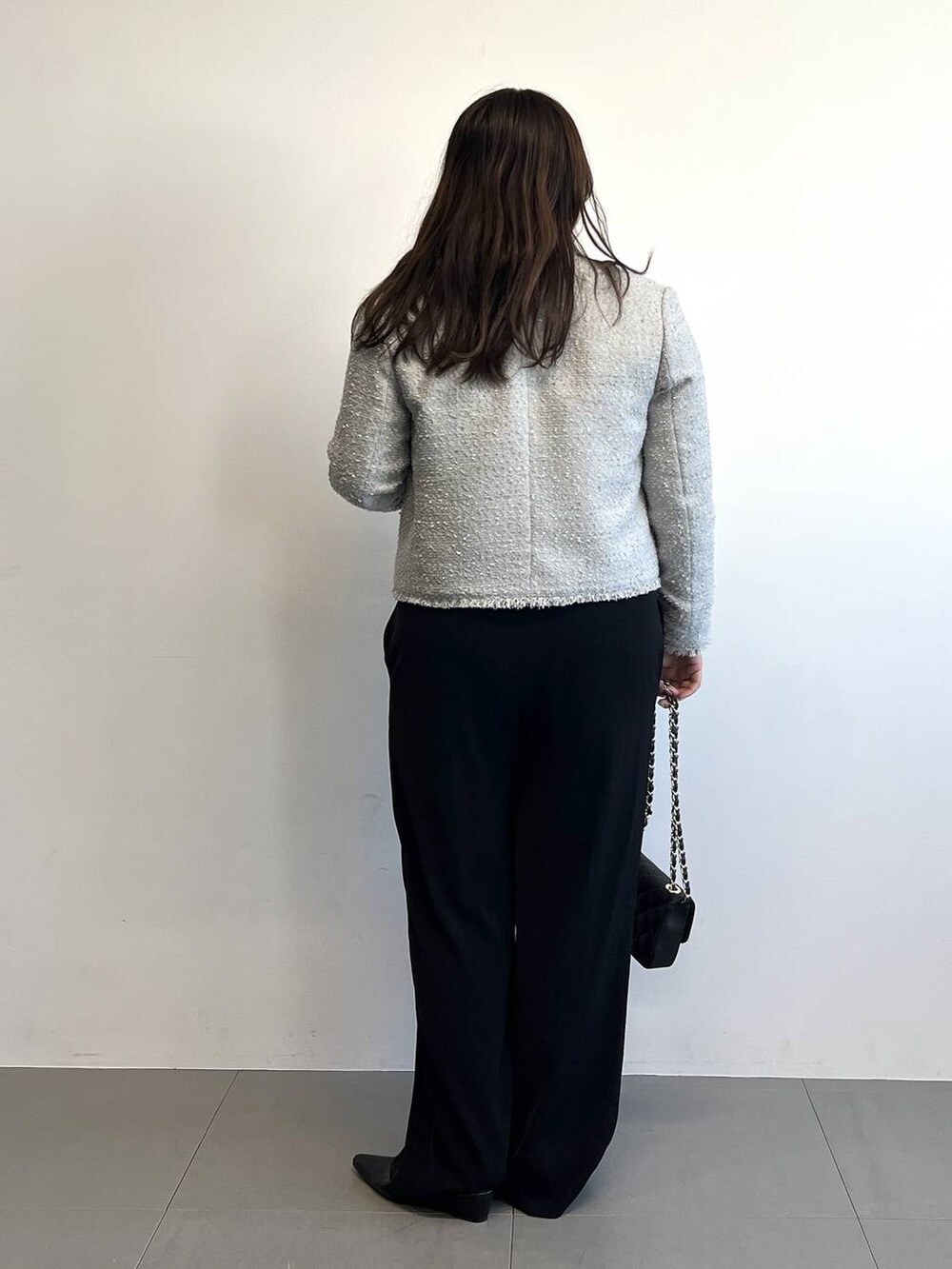 ブラック系のつなぎ/オールインワン、グレー系のノーカラージャケット、ブラック系のパンプスを着用したレディースの冬コーディネートの4枚目の写真