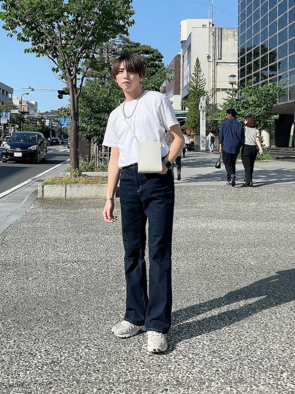 ベージュ系のスニーカー、ホワイト系のバッグを着用したメンズの春コーディネートの2枚目の写真