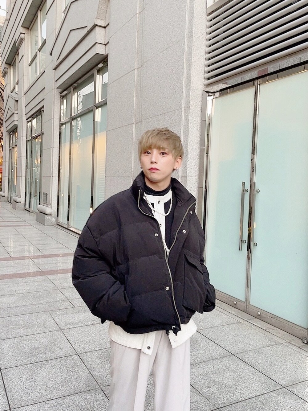 ブラック系のスニーカー、ブラック系のダウンジャケット/コート、ブラック系のカーディガン/ボレロを着用したメンズの冬コーディネートの3枚目の写真