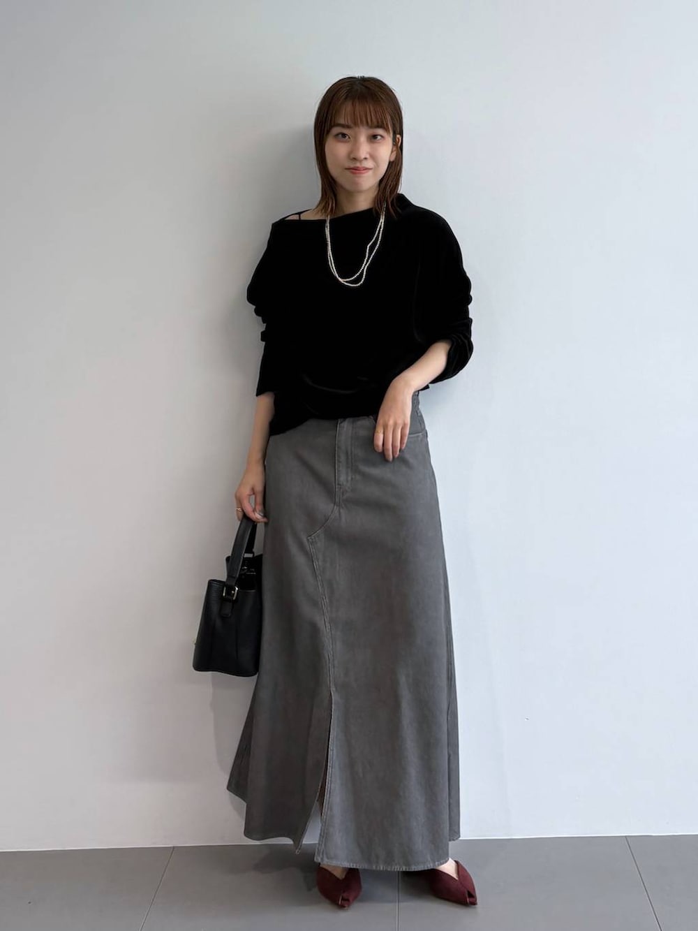 レッド系のパンプス、ブラック系のショルダーバッグ、ブラック系のTシャツ/カットソーを着用したレディースの夏コーディネートの5枚目の写真