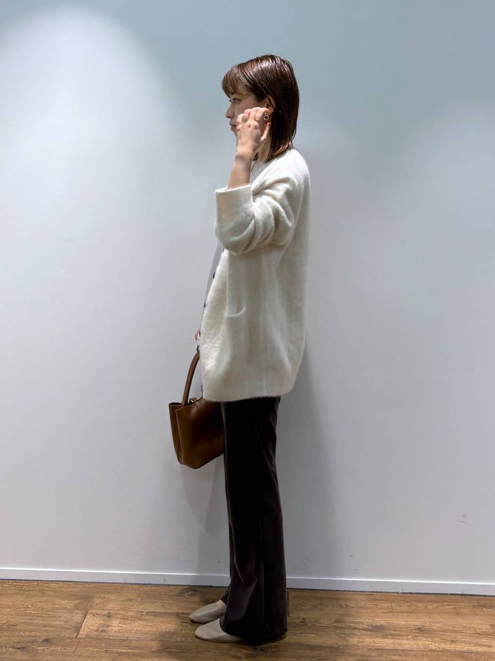 ホワイト系のシャツ/ブラウス、ベージュ系のカーディガン/ボレロ、ブラウン系のショルダーバッグを着用したレディースの秋コーディネートの2枚目の写真