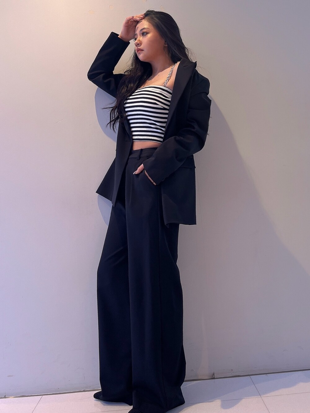 その他のキャミソール、ブラック系のテーラードジャケット、ブラック系のその他パンツを着用したレディースの春コーディネートの2枚目の写真