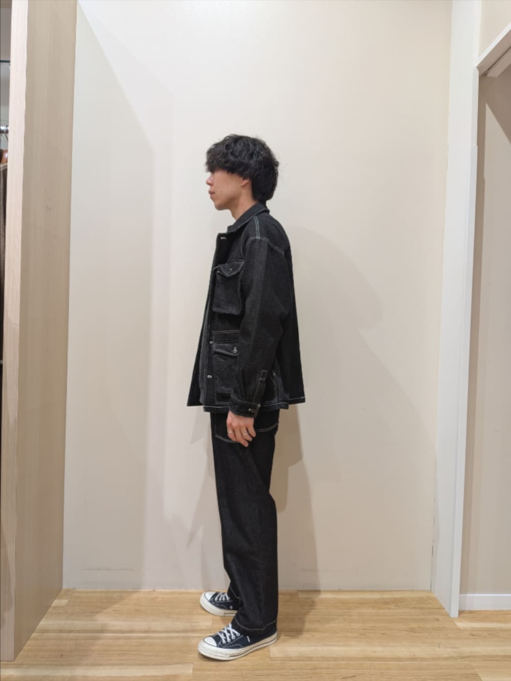 ブラック系のカバーオール、ブルー系のデニムパンツ、その他のスウェットを着用したメンズの冬コーディネートの2枚目の写真