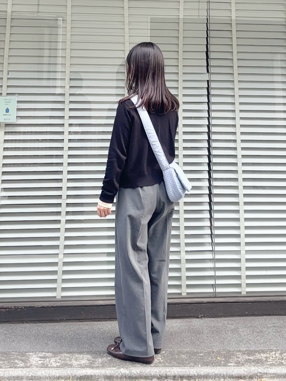 ブルー系のショルダーバッグ、ブラック系のカーディガン/ボレロ、イエロー系のTシャツ/カットソーを着用したレディースの春コーディネートの2枚目の写真