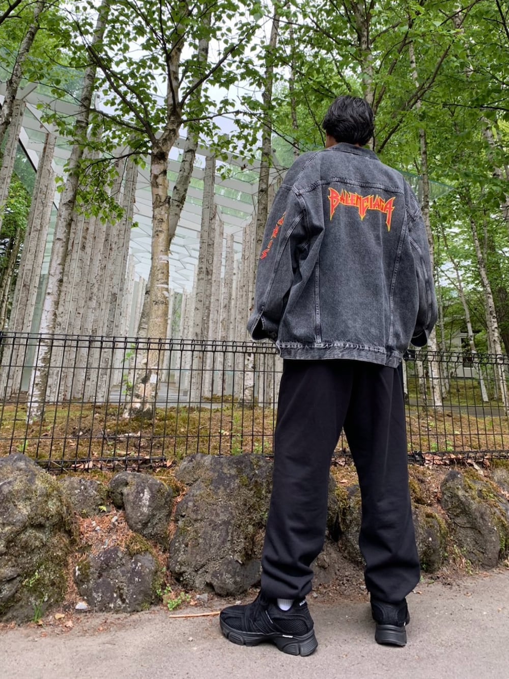 ブラック系のスウェットパンツ、ブラック系のデニムジャケット、ブラック系のスニーカーを着用したメンズの春コーディネートの3枚目の写真