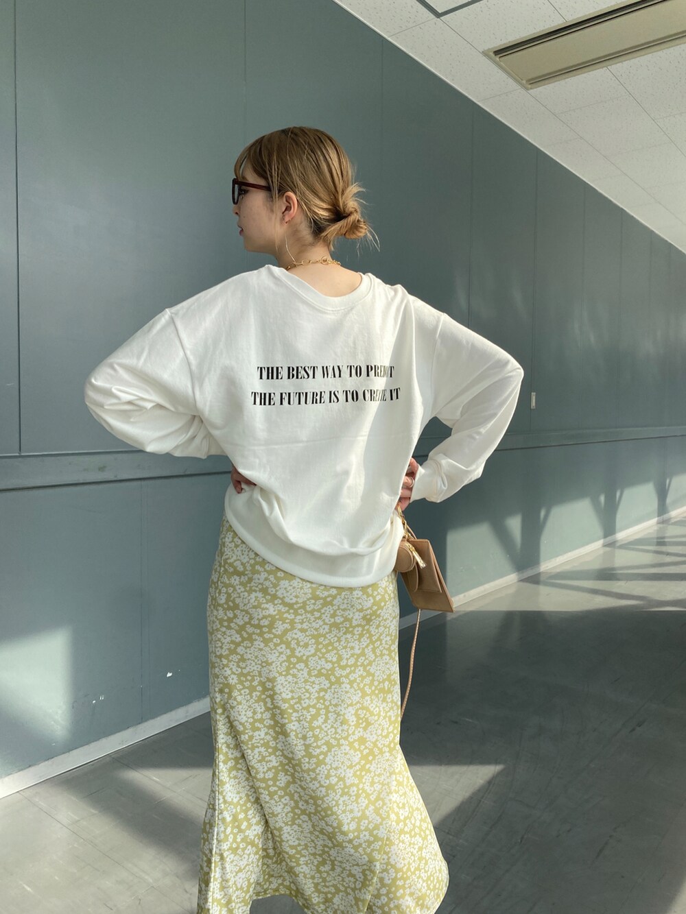 ホワイト系のTシャツ/カットソー、イエロー系のスカート、ベージュ系のショルダーバッグを着用したレディースの冬コーディネートの4枚目の写真