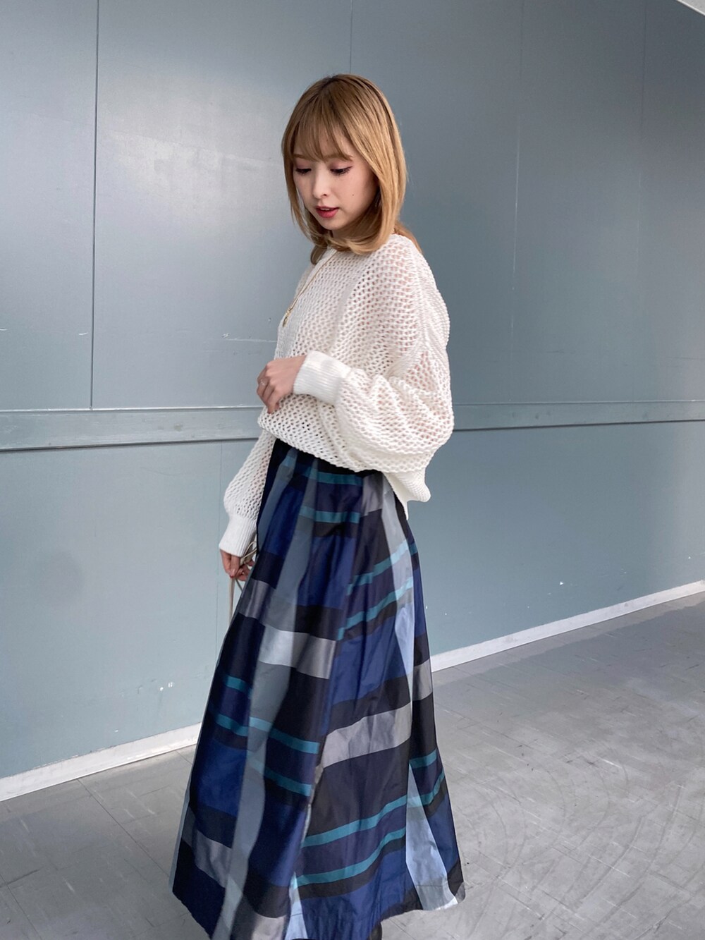 ホワイト系のニット/セーター、ホワイト系のスカート、ベージュ系のショルダーバッグを着用したレディースの冬コーディネートの3枚目の写真