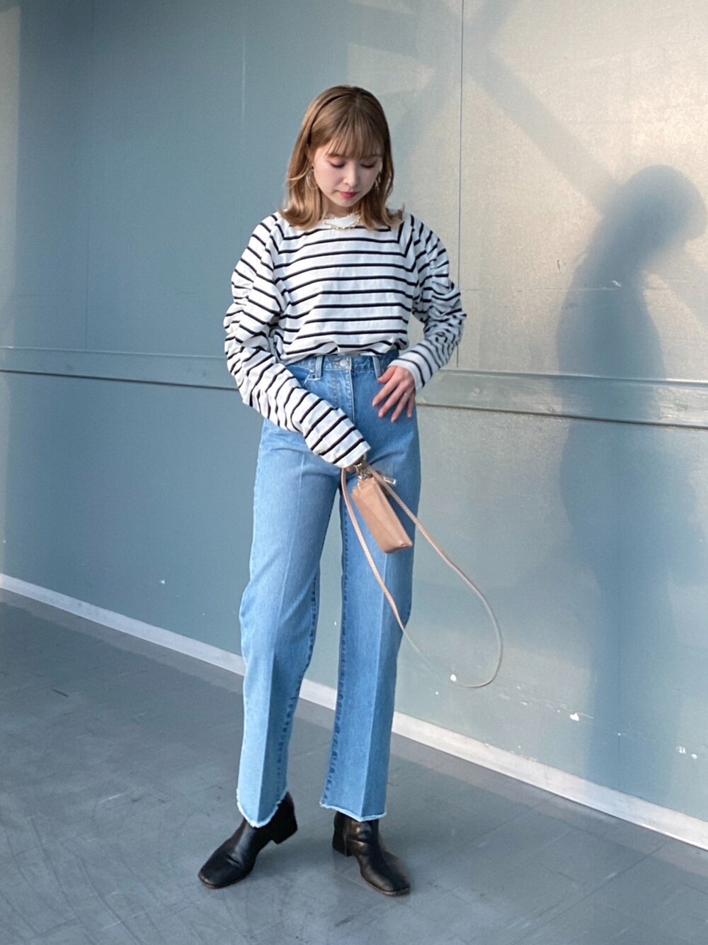 ブルー系のデニムパンツ、その他のTシャツ/カットソー、ホワイト系のカーディガン/ボレロを着用したレディースの冬コーディネートの4枚目の写真