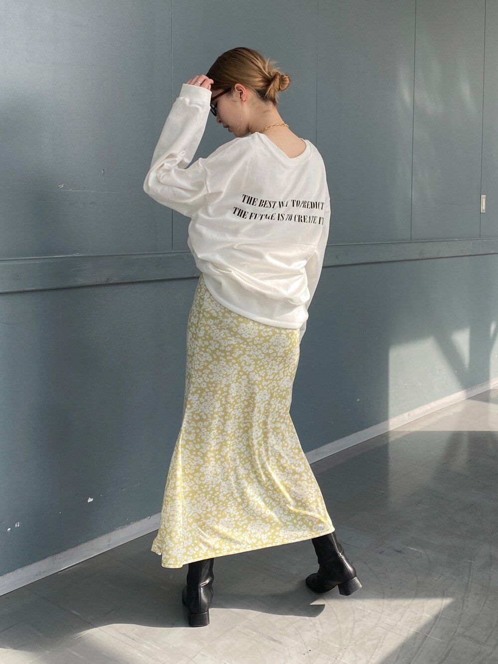 ホワイト系のTシャツ/カットソー、イエロー系のスカート、ベージュ系のショルダーバッグを着用したレディースの冬コーディネートの2枚目の写真