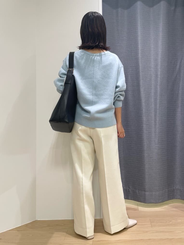 ホワイト系のその他パンツ、ブルー系のニット/セーター、ブラック系のトートバッグを着用したレディースの秋コーディネートの2枚目の写真