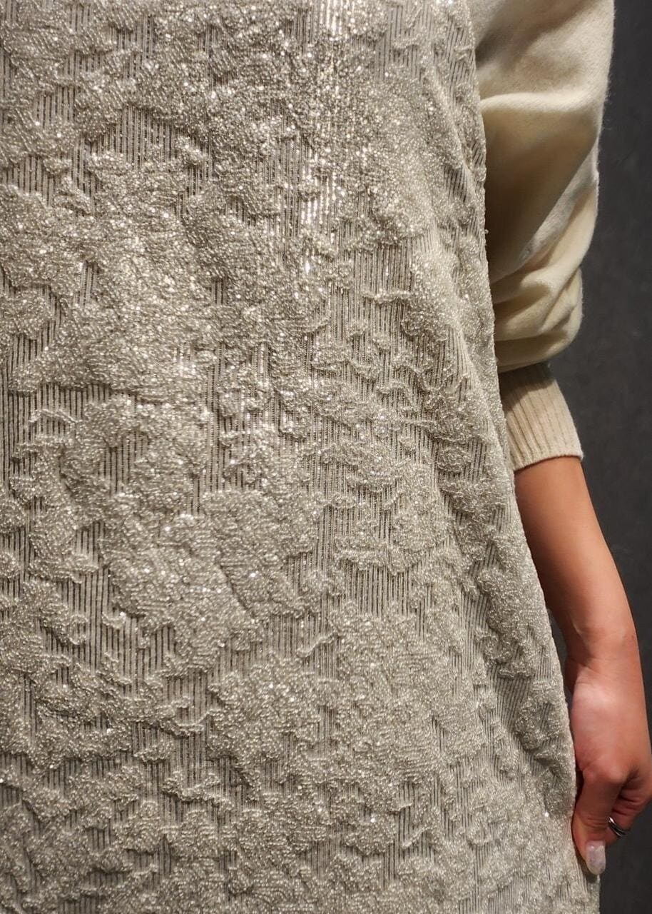 ブルー系のデニムパンツ、グレー系のハンドバッグ、ホワイト系のワンピースを着用したレディースの冬コーディネートの6枚目の写真