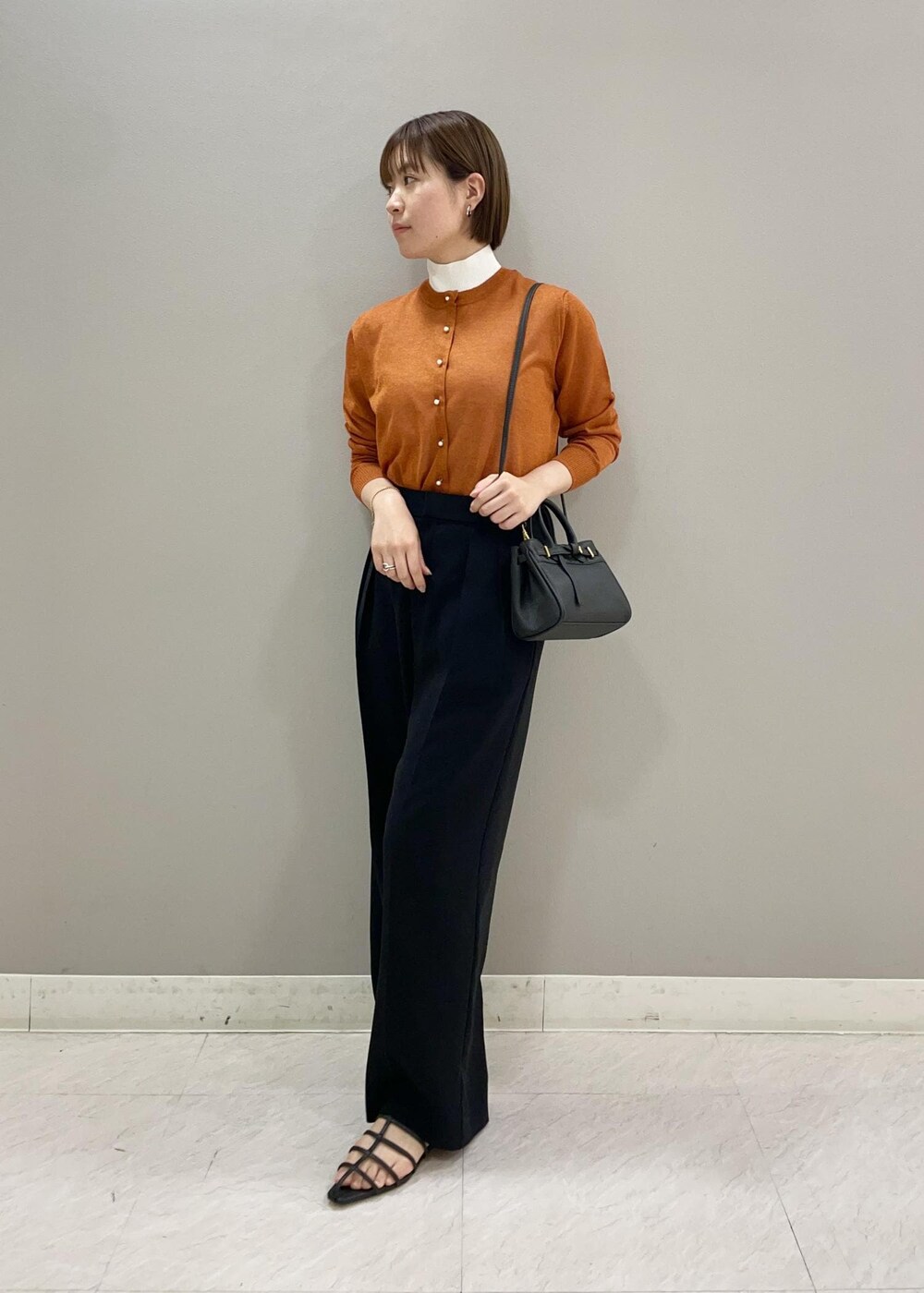 ブラック系のその他パンツ、ブラック系のハンドバッグ、ブラック系のサンダルを着用したレディースの春コーディネートの2枚目の写真