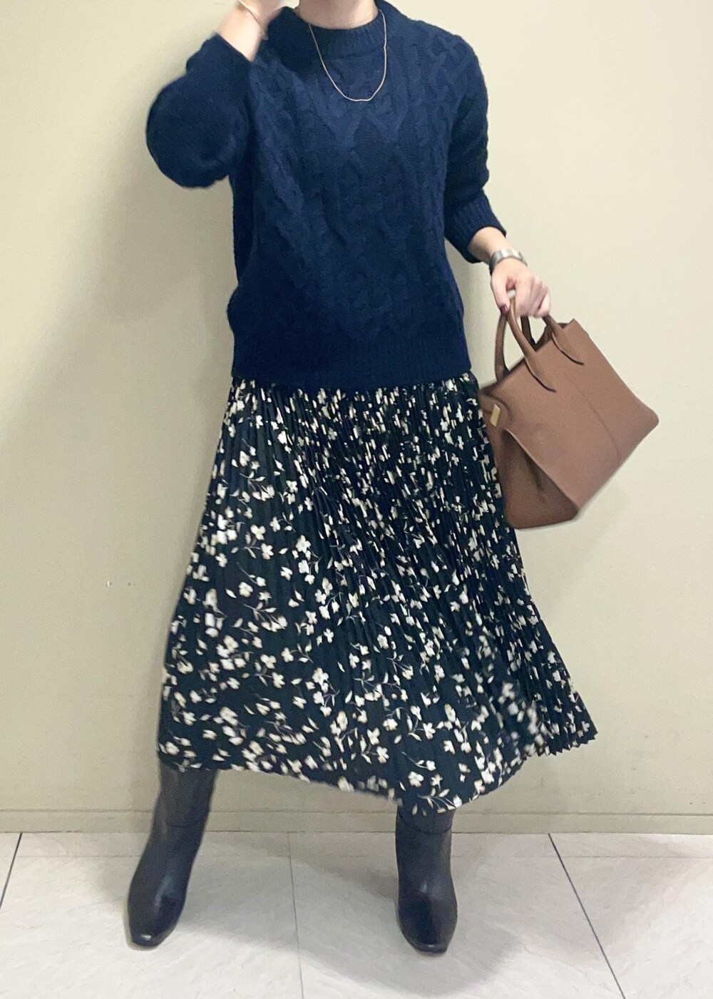 ブラウン系のブーツ、イエロー系のトートバッグ、ブラック系のスカートを着用したレディースの秋コーディネートの3枚目の写真