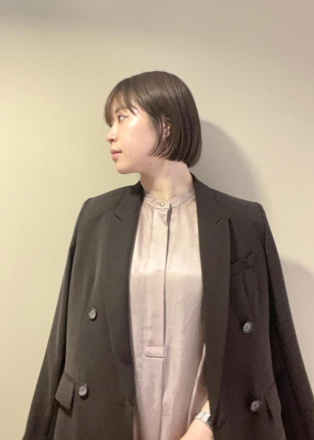 ホワイト系のハンドバッグ、ブラック系のサンダル、ブラウン系のテーラードジャケットを着用したレディースの春コーディネートの8枚目の写真