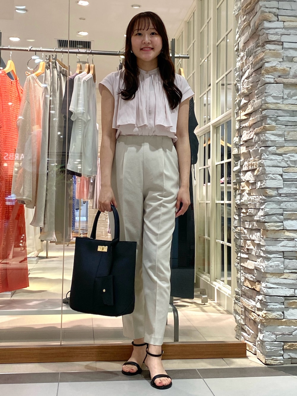 ブラック系のトートバッグ、シルバー系のサンダル、ベージュ系のその他パンツを着用したレディースの春コーディネートの5枚目の写真